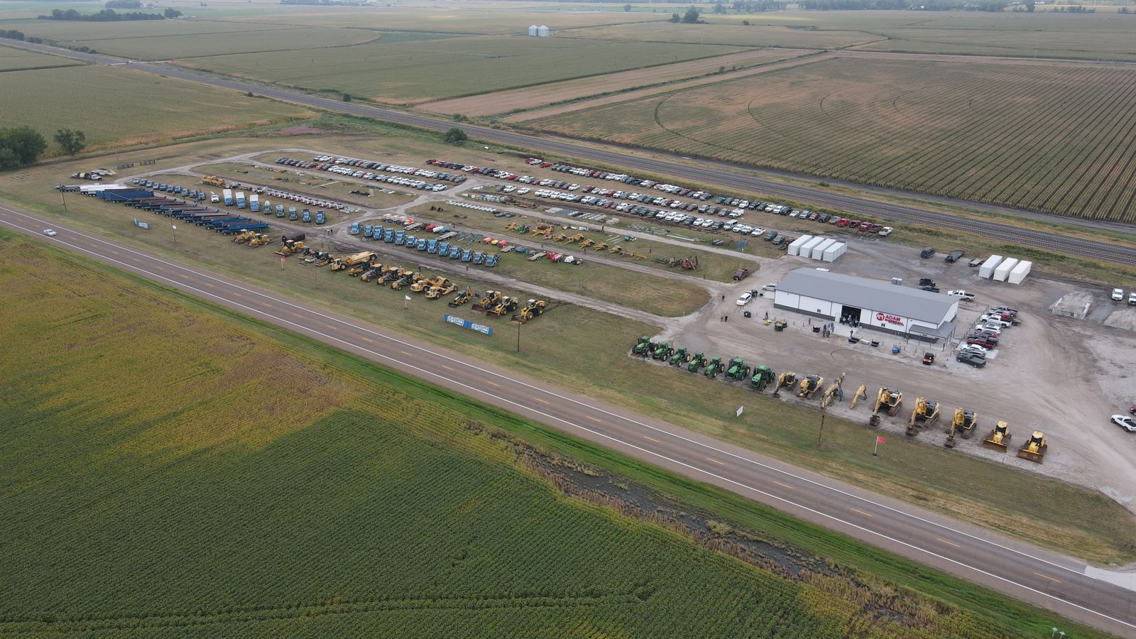 Aerial view of the Blessing Construction auction lineup at the Adam Marshall auction yard on Highway 30, Kearney, Nebraska